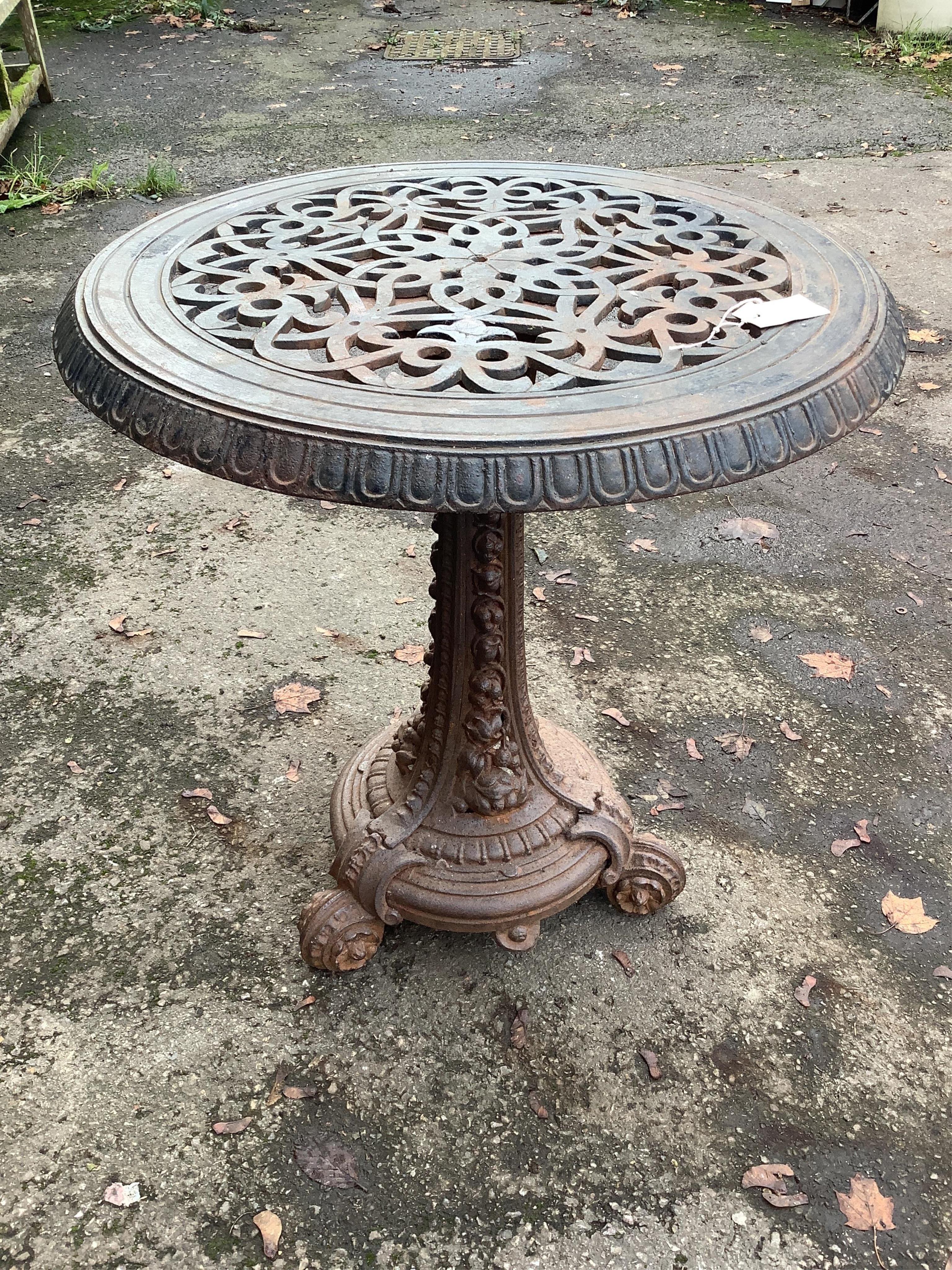 An unusually heavy Victorian cast iron garden table, diameter 70cm, height 72cm. Condition - oxidised, otherwise good